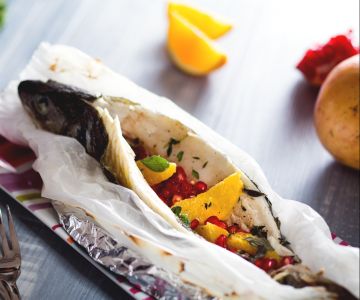 Lubina en papillote con cítricos y granada