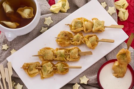 Brochetas de tortellini fritos con salsa de nata y parmesano