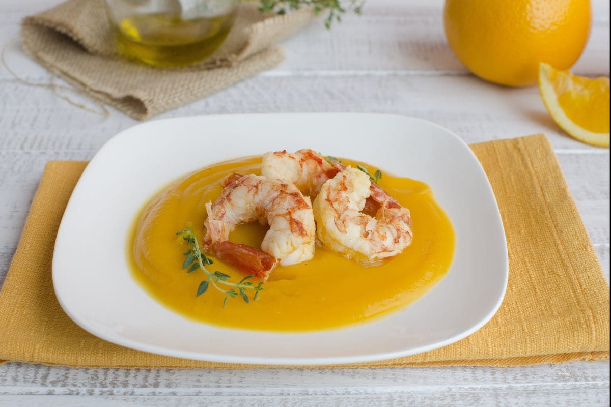 Gambas a la naranja sobre crema de calabaza