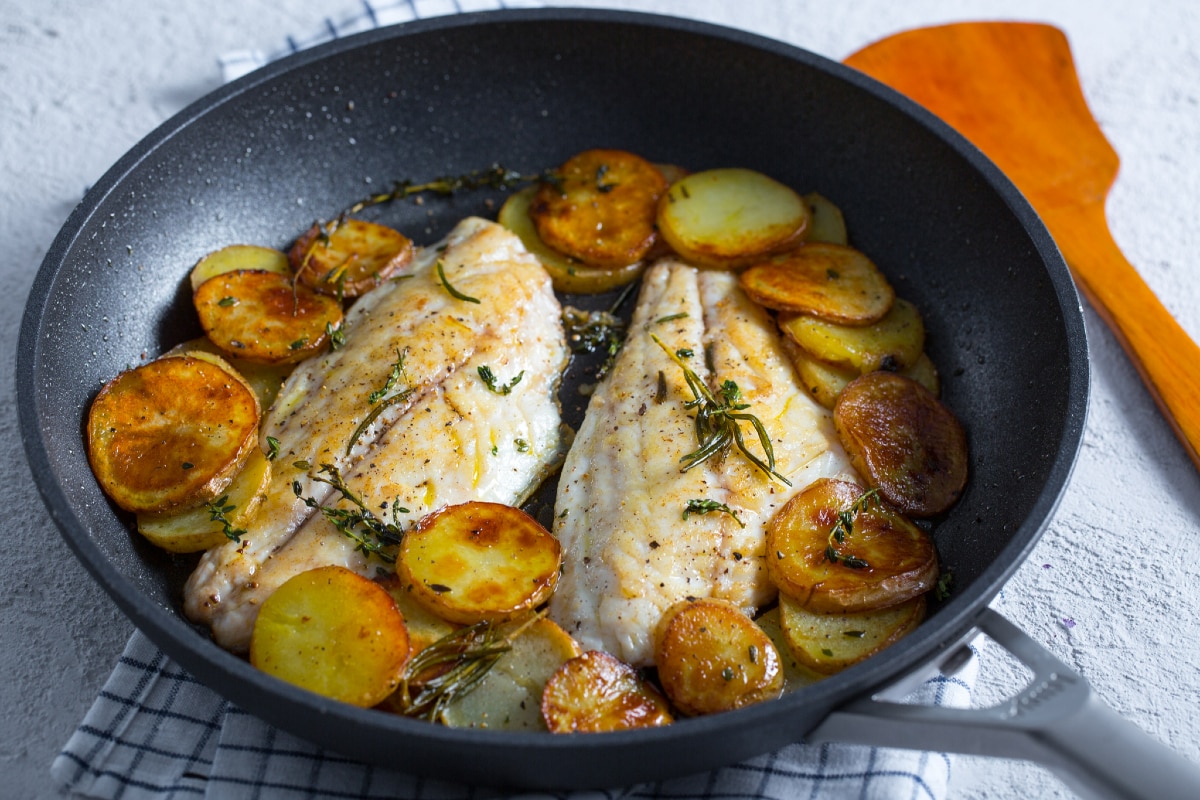 Filetes de dorada y patatas en sartén