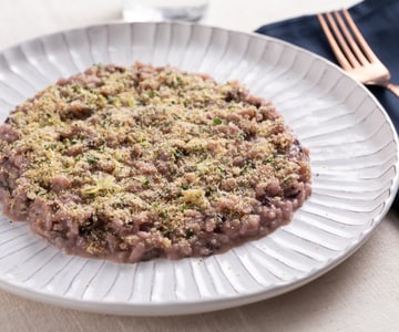 Risotto con achicoria, mantequilla de anchoas y pan aromático