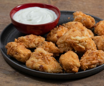 Pechuga de pollo empanada en palitos de pan