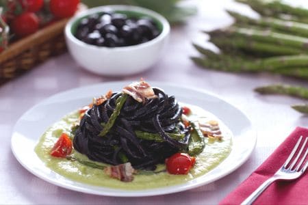 Espaguetis a la guitarra al negro de aceitunas con espárragos y panceta